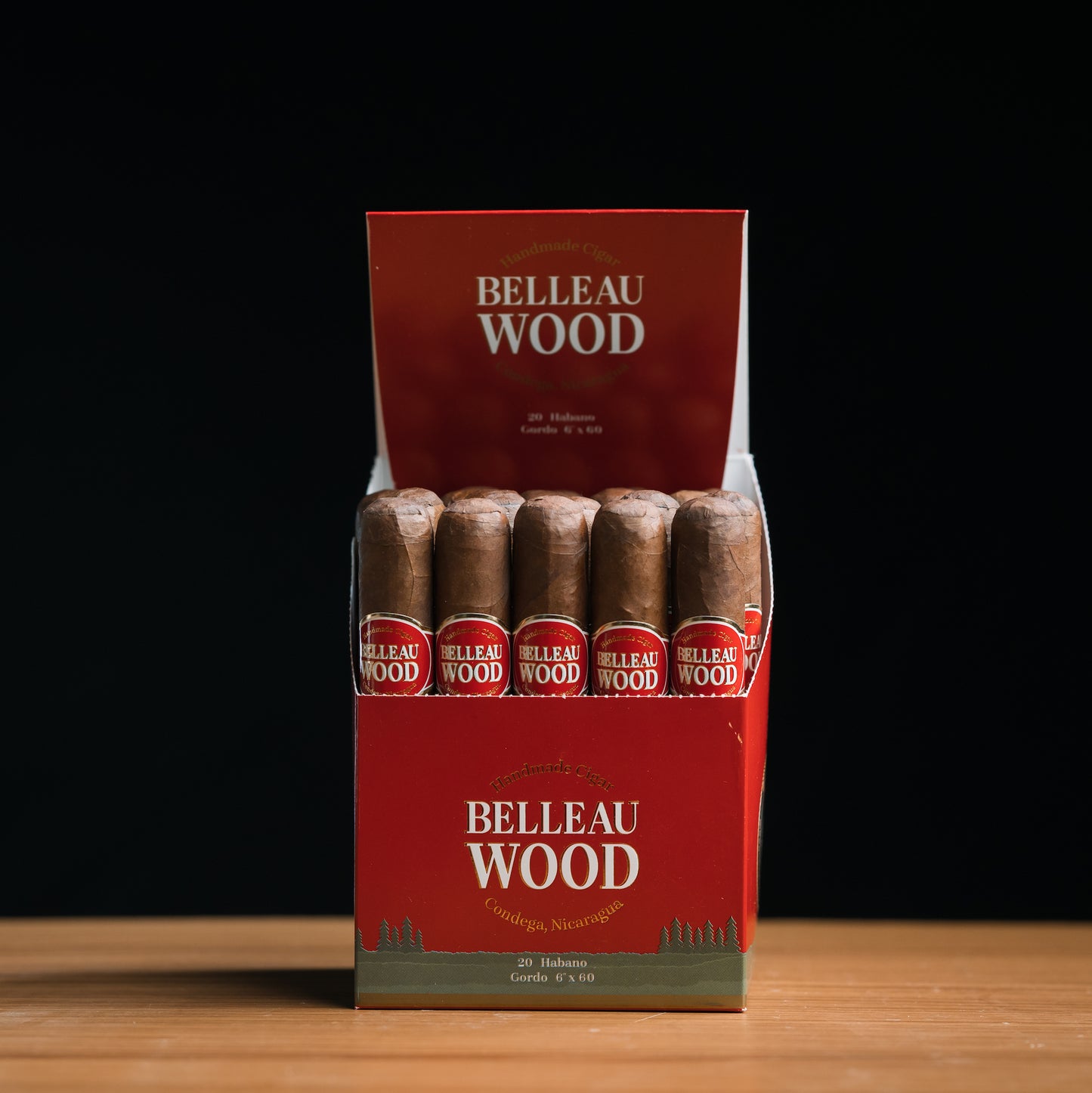 A box of Belleau Wood Habano Gordo cigars, displaying multiple cigars with brown wrappers and red labeling.