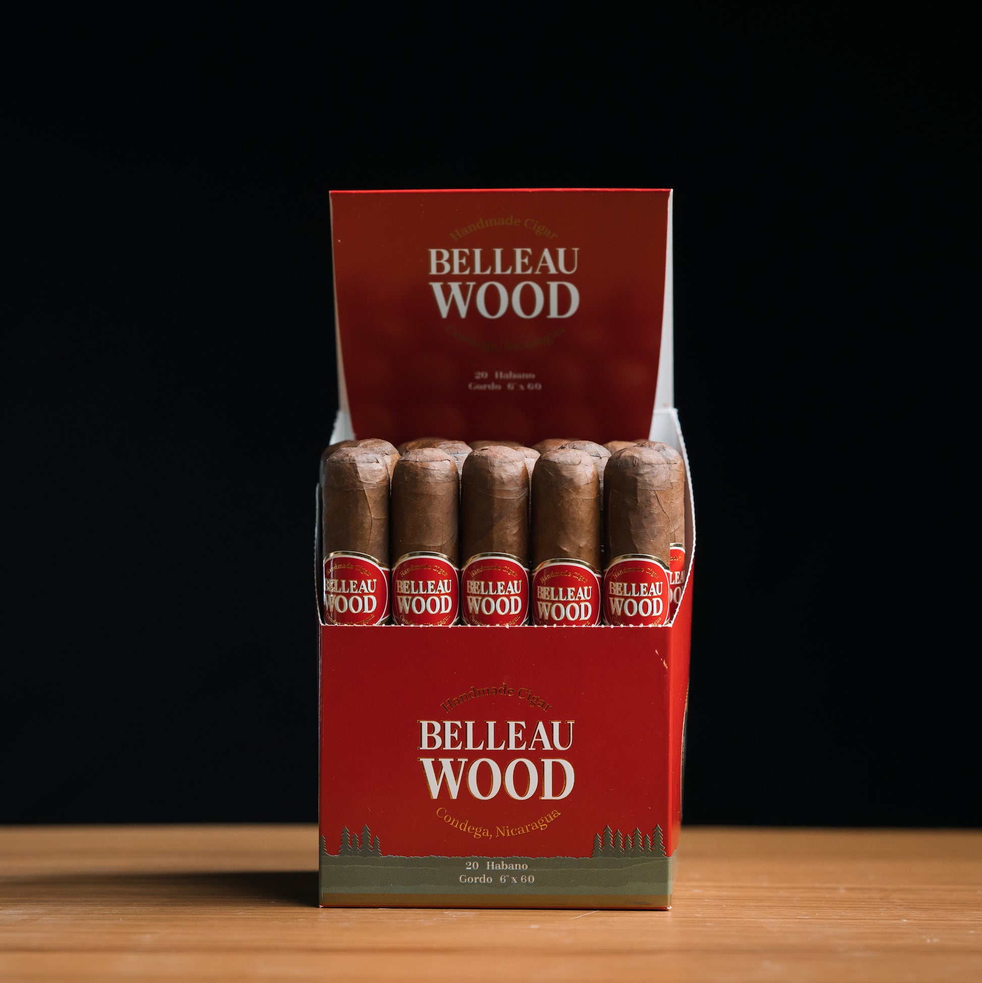 A box of Belleau Wood Habano Gordo cigars, displaying multiple cigars with brown wrappers and red labeling.
