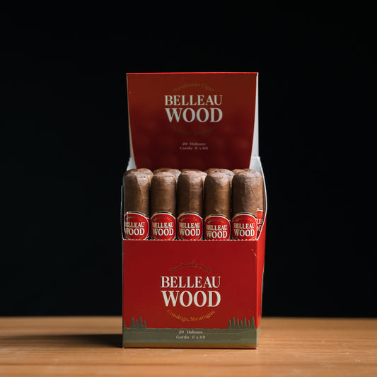 A box of Belleau Wood Habano Gordo cigars, displaying multiple cigars with brown wrappers and red labeling.